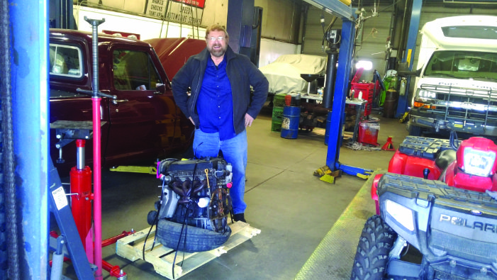 Pastor Wayne with engine in shop